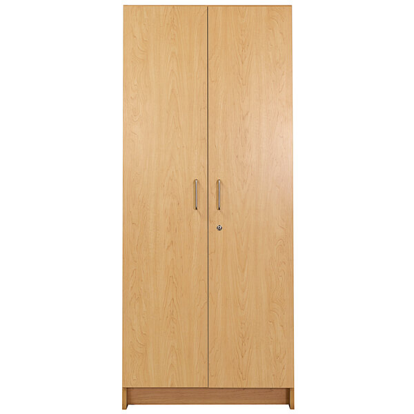 A Tot Mate maple tall wooden cabinet with two doors and handles.