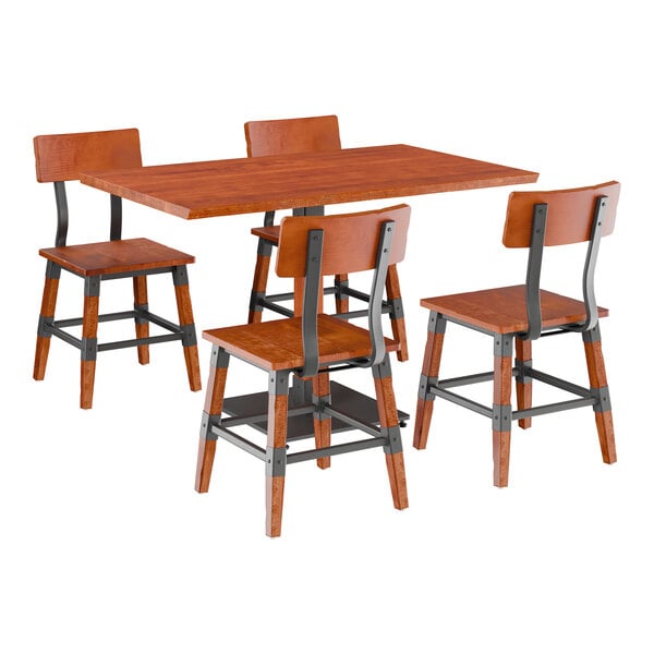 A Lancaster Table & Seating rustic mahogany wooden table and chairs with a black metal frame.