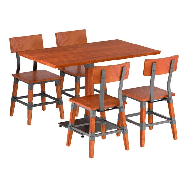 A rectangular wooden table with a rustic mahogany finish is paired with four matching chairs featuring metal accents and wooden seats and backs.