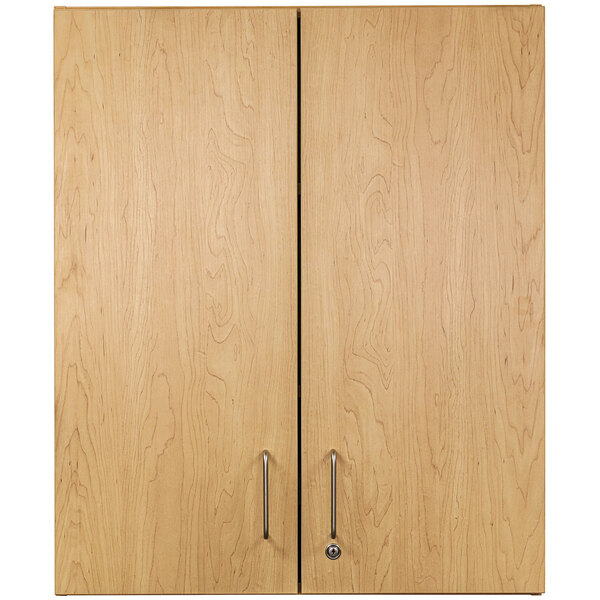 A Tot Mate maple wooden wall cabinet with two doors and handles.