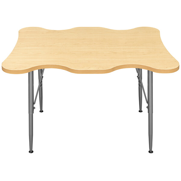 A rectangular wooden Tot Mate table with metal legs.