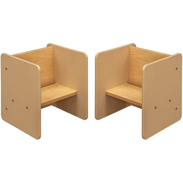 A beige and maple laminate activity cube with a shelf and a step.