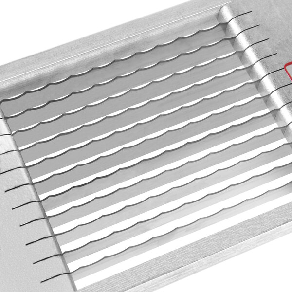 A close-up of a metal grid with a red handle.