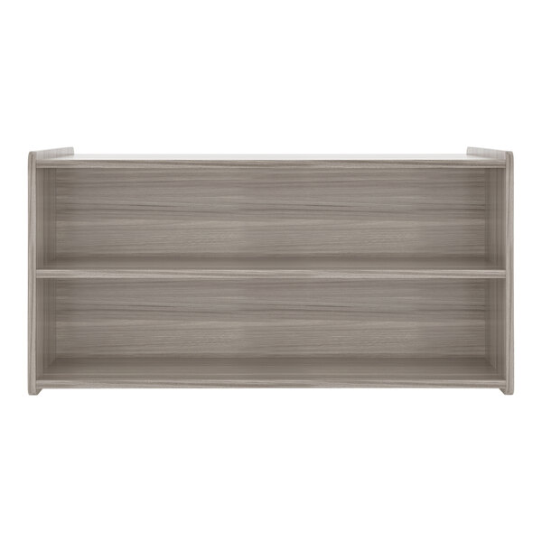 A wooden Tot Mate toddler double sided storage shelf in shadow elm with three shelves.