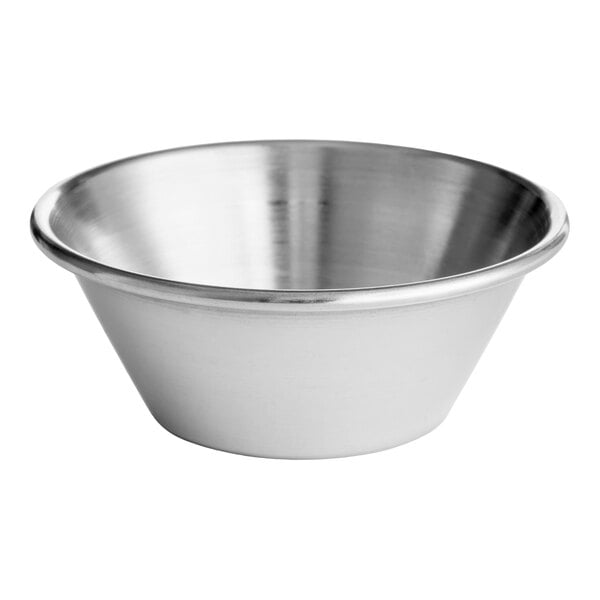 A small round stainless steel sauce cup.