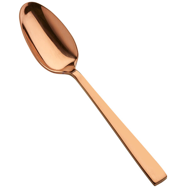 A close-up of a Bon Chef rose gold teaspoon with a handle.