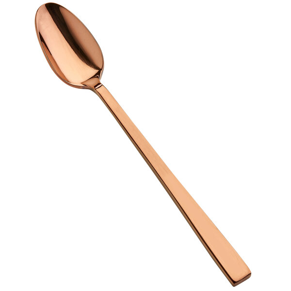 A close-up of a Bon Chef rose gold iced tea spoon with a long handle.