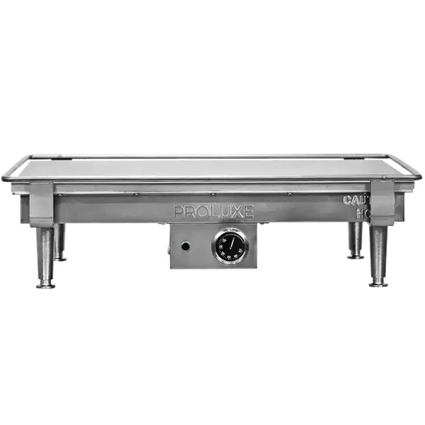 A Proluxe stainless steel tortilla flat grill on a metal table.