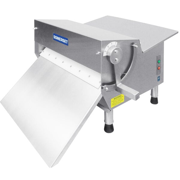 A Somerset countertop dough sheeter with a metal cover.