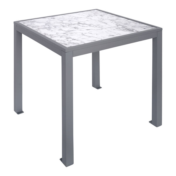 A BFM Seating Surf table with a soft gray marble top and metal legs.