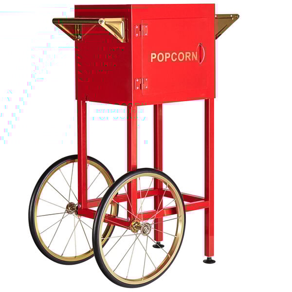 A red Carnival King popcorn cart with a popcorn machine on it.