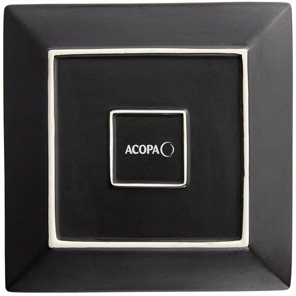 A black square Acopa stoneware plate with white trim and text.
