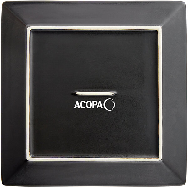 A black square Acopa stoneware plate with white text.
