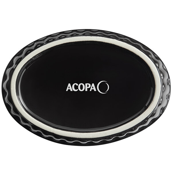 An oval black Acopa stoneware dish with fluted edges.