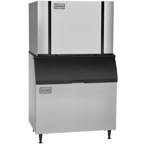 A close-up of a large stainless steel and black Ice-O-Matic air cooled ice machine.