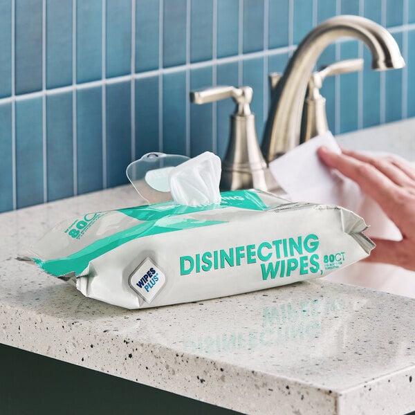 A package of WipesPlus 8" x 7" 80 count lemon scent alcohol-free single use surface disinfecting wipes on a bathroom counter.