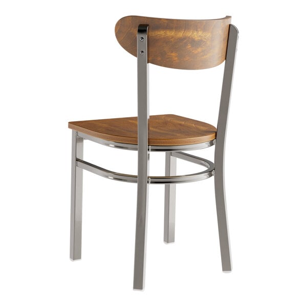 A Lancaster Table & Seating Boomerang chair with a wood seat and metal frame.