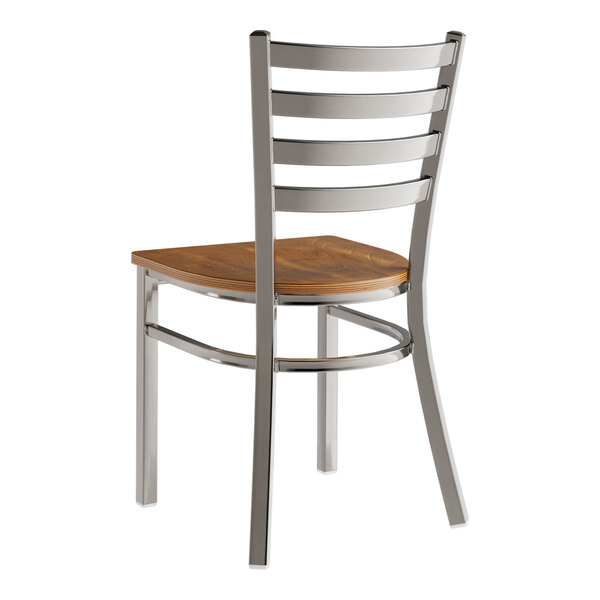 A Lancaster Table & Seating metal ladder back chair with a wood seat.