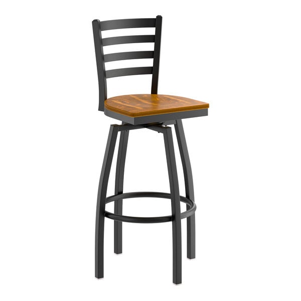A black metal ladder back swivel bar stool with a vintage wood seat.