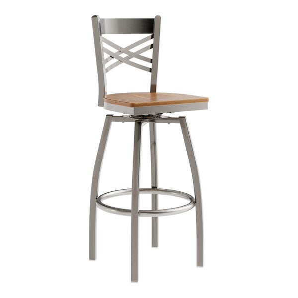 A Lancaster Table & Seating stainless steel swivel bar stool with a vintage wood seat.