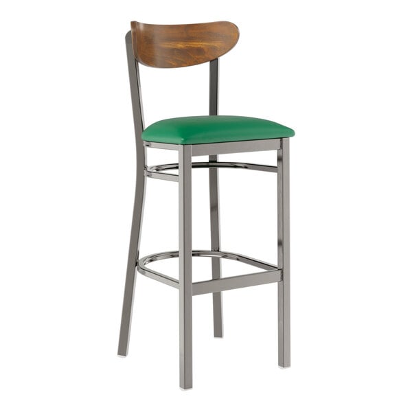 A Lancaster Table & Seating bar stool with a green vinyl seat and metal legs.