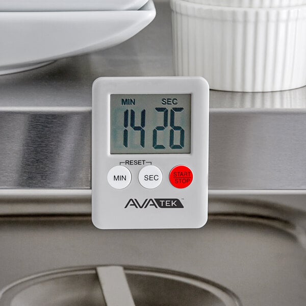 An AvaTime Mini Digital kitchen timer on a stainless steel counter.