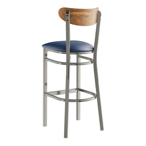 A Lancaster Table & Seating bar stool with a blue vinyl seat.