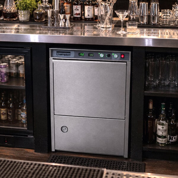 A stainless steel Champion high temperature undercounter dishwasher installed beneath a bar counter.