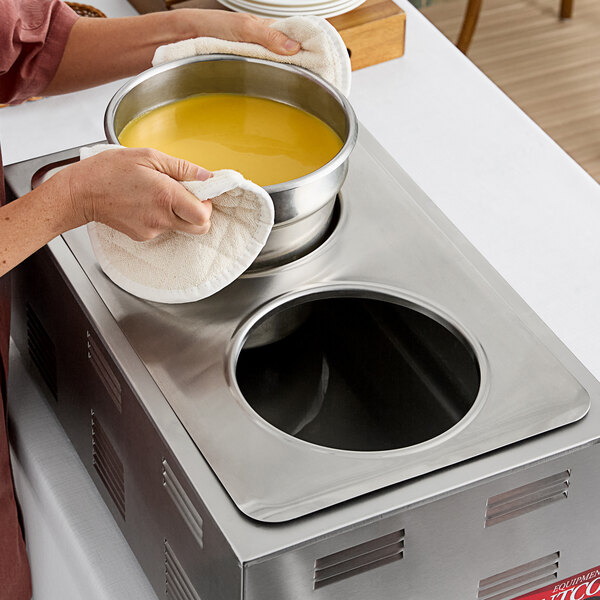 A stainless steel steam table adapter plate with two circular holes, designed to hold 7-quart insets.
