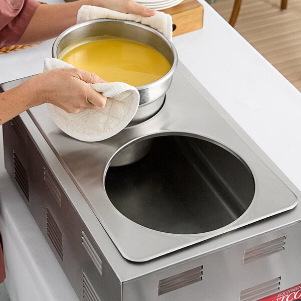 A stainless steel steam table adapter plate with two circular holes for holding 7 quart and 11 quart insets.