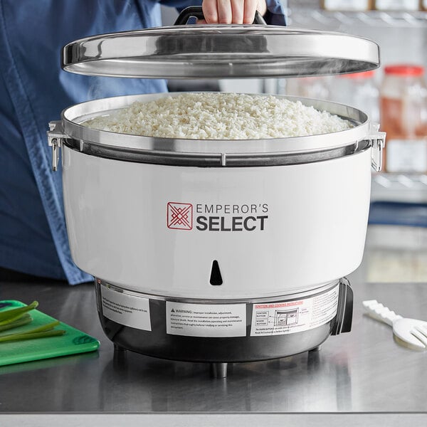 An Emperor's Select gas rice cooker with rice cooking in a pot.