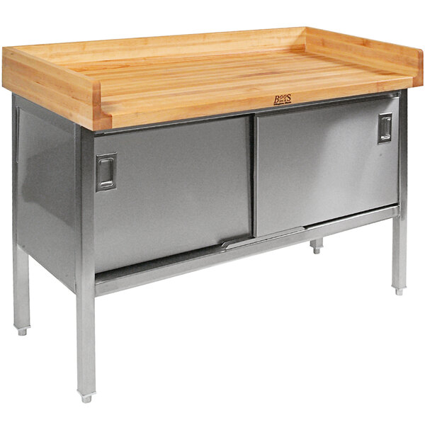 A wood top work table with a stainless steel enclosed base with sliding doors.