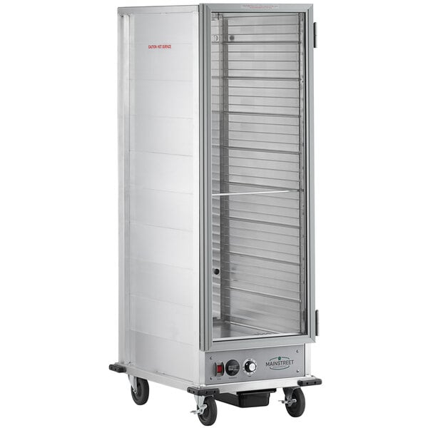 A large stainless steel MainStreet Equipment heated holding cabinet with a clear door on wheels.
