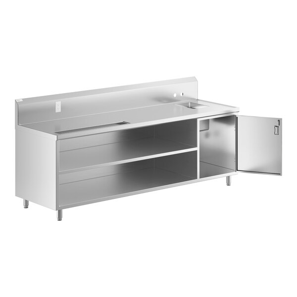 A Regency stainless steel beverage table with a sink and door open.