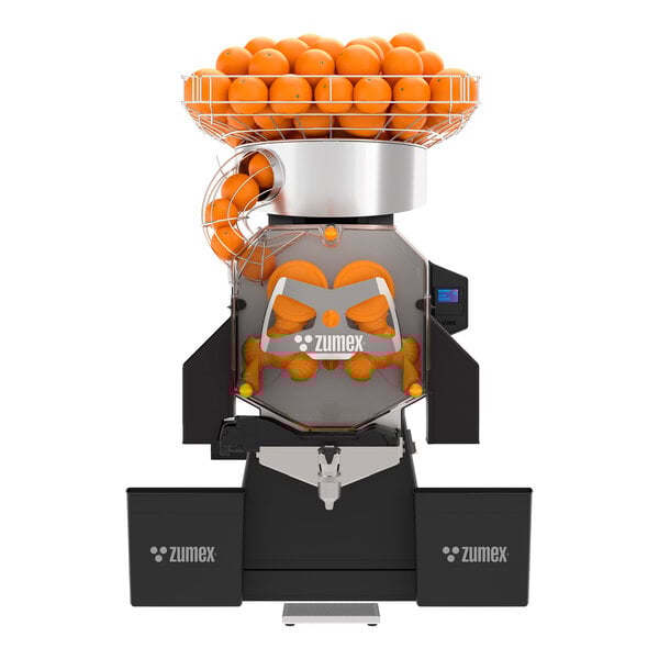 A commercial automatic feed juicer with a large orange hopper and dual waste bins, designed for high-capacity self-service juicing.