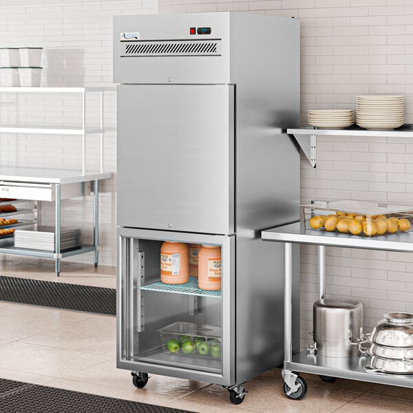 An Avantco stainless steel reach-in refrigerator with glass half doors in a large kitchen.