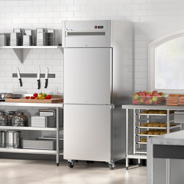 An Avantco stainless steel reach-in refrigerator with solid half doors in a kitchen.