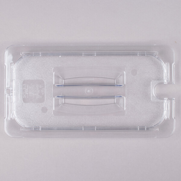 A Carlisle clear plastic pan lid with metal handles.