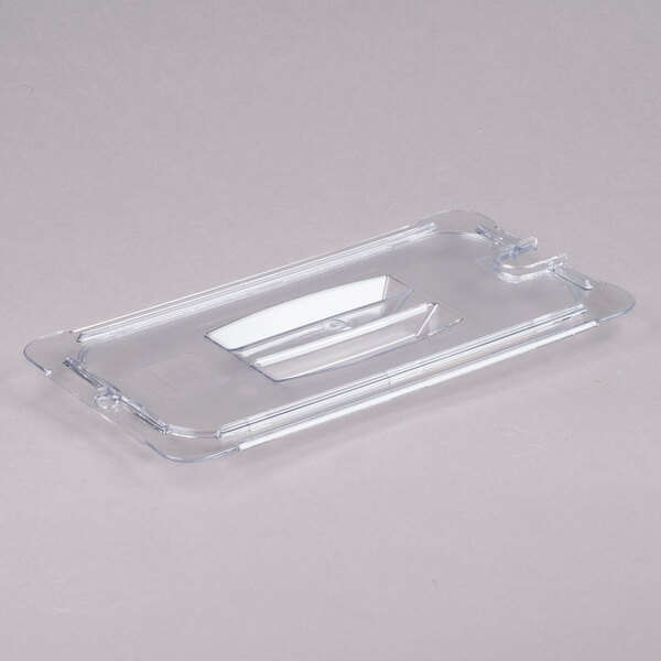 A Carlisle clear plastic lid with a white handle and spoon notch.