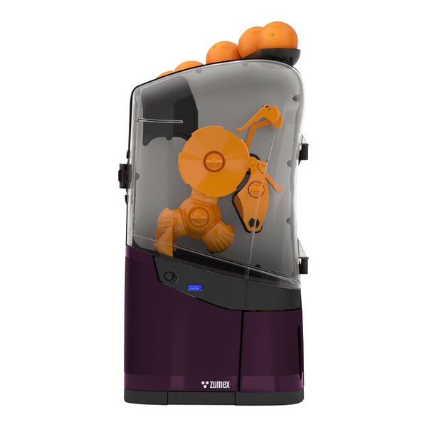 A Zumex Minex commercial juicer filled with oranges on a counter.