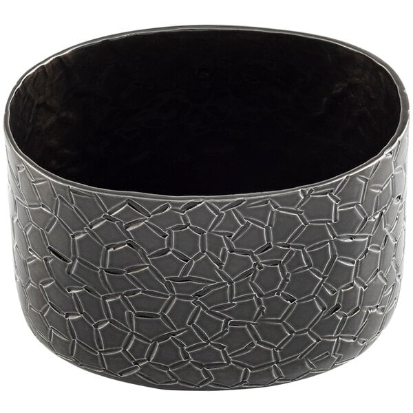 A black oval aluminum sugar packet holder with a crackle pattern.