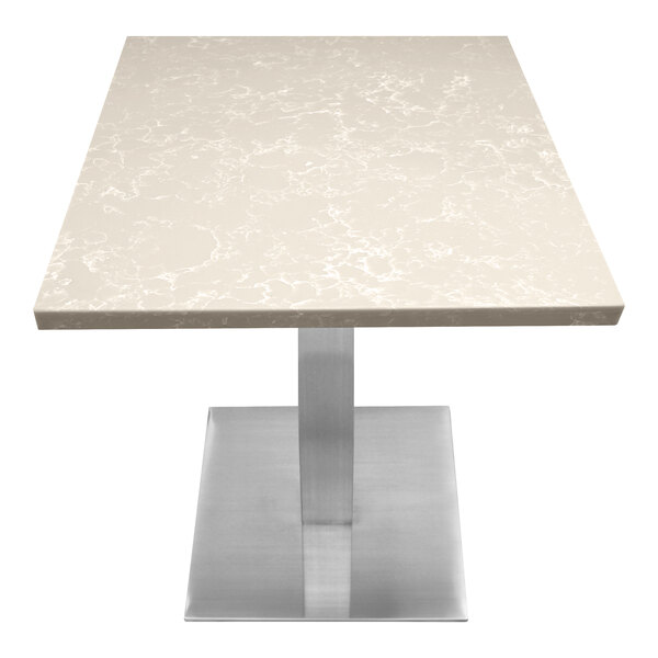 A white Art Marble Furniture quartz table top on a metal table base.