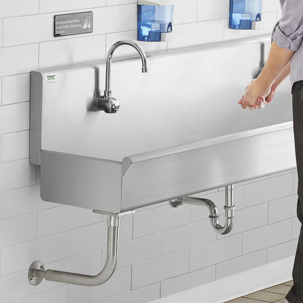 a hand reaching out to a faucet