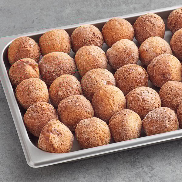 A tray of Rich's Ready-to-Finish Jumbo French Toast Filled Donut Bites on a table.