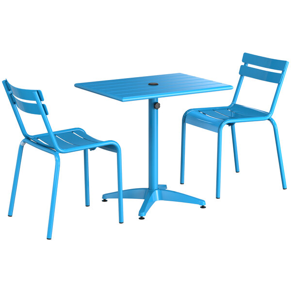 A blue table and two chairs set up on a white background.