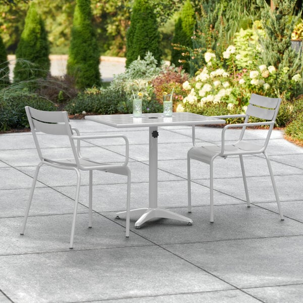 A white table and chairs on an outdoor patio.