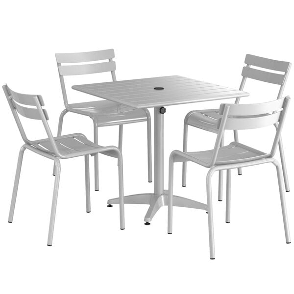 A Lancaster Table & Seating silver powder-coated aluminum table with 4 chairs.