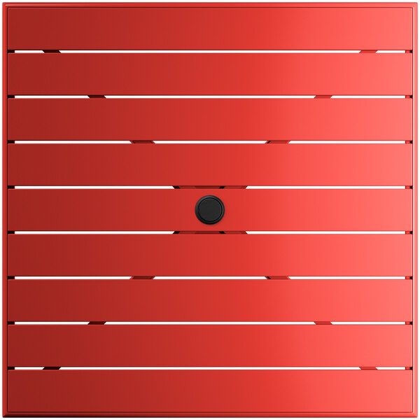 A red square Lancaster Table & Seating outdoor table top with a black umbrella hole.