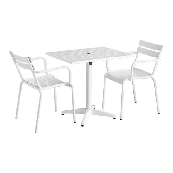 A white table and two chairs with a white background.