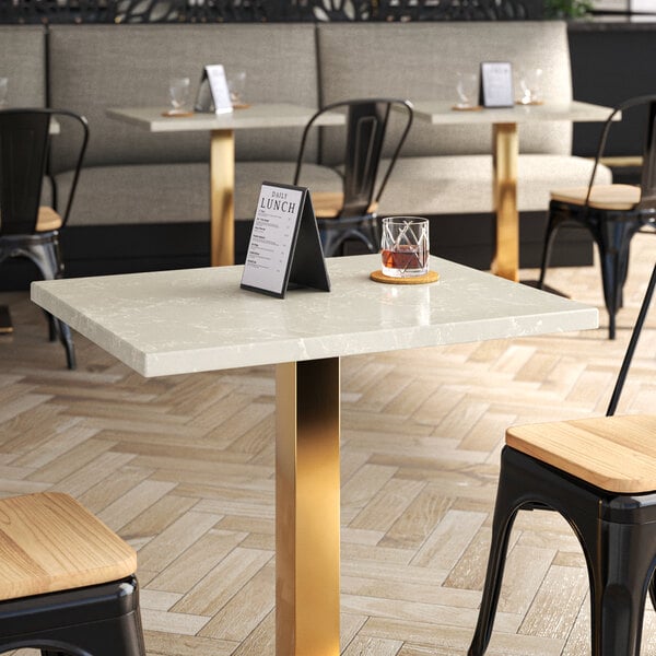 A table with a nebula gray quartz top in a restaurant dining area.